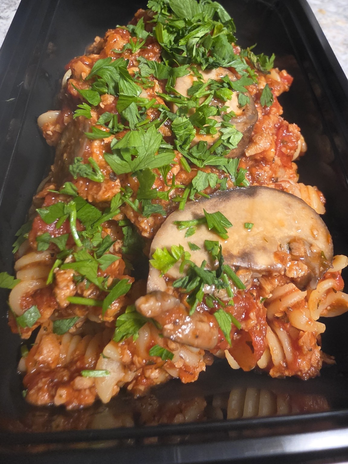TVP Rotini Bolognese with tomato sauce, sliced mushrooms and fresh parsley